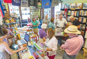 WILDFLOWER WEEK:  Local author John Fielder signed copies of his wildflower books at Townie Books on Friday, July 15.       photo by Lydia Stern