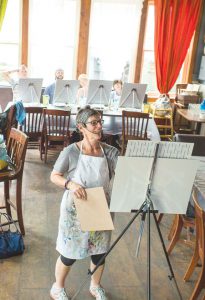 PRETTY PAINTINGS:  Becky Chappell taught Cocktails and Canvas at Bonez on Tuesday, June 28.       photo by Lydia Stern